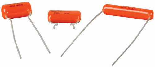 Three "orange drop" capacitors with different values and sizes.